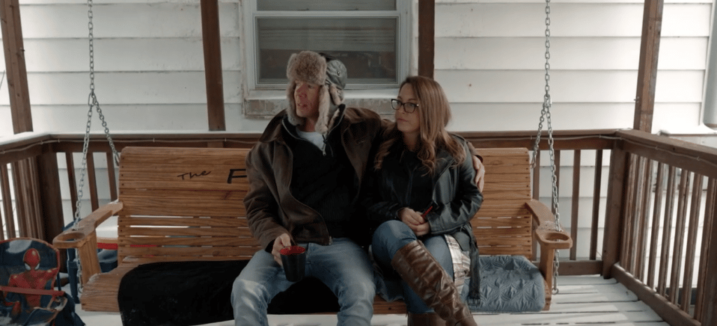 A Groups member sits with his wife on their porch